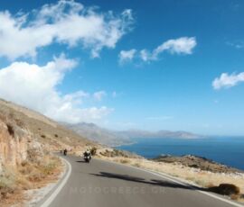 riding along the rugged coastline of Mani peninsula, on tour with MotoGreece